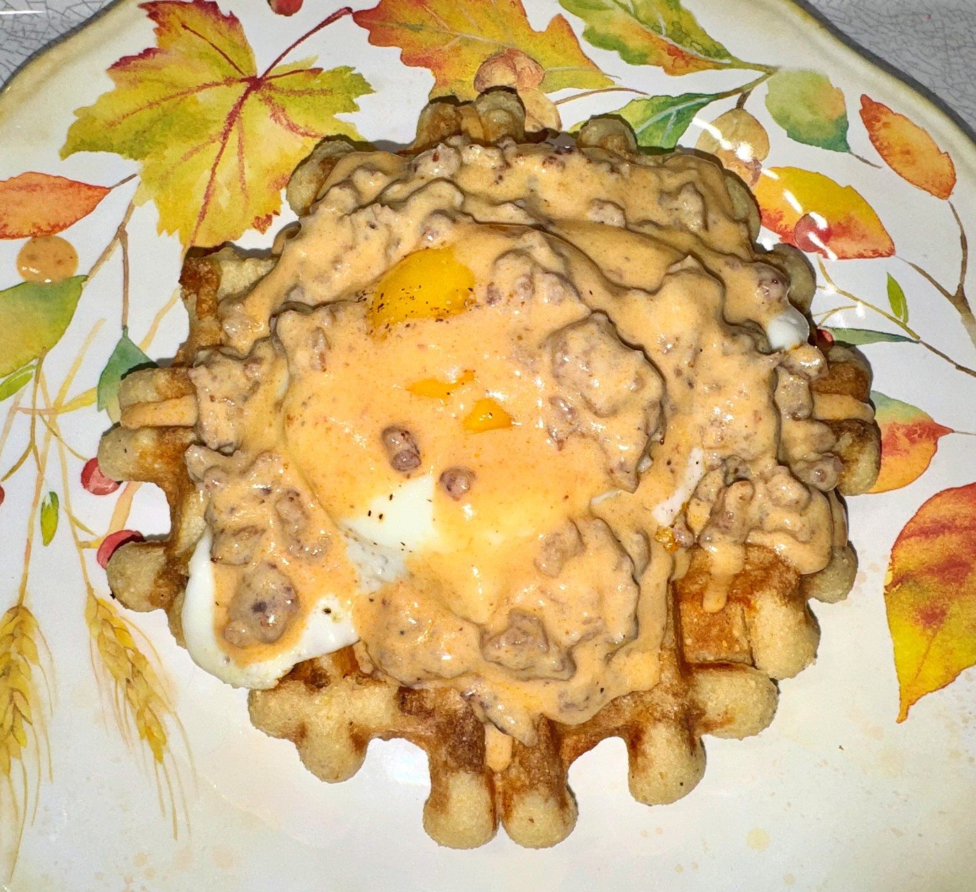 Miso-butter cornbread waffle Benedict with smoky sausage gravy
